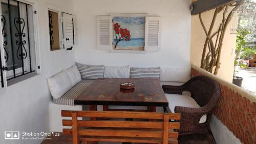 a small table and chairs on a balcony at Casa Beja in Sant Francesc Xavier