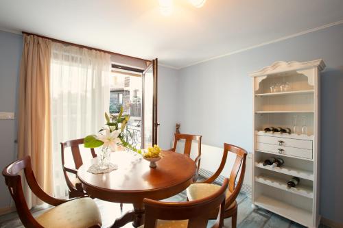 a dining room with a table and chairs and a window at Guest House Soirée in Nesebar