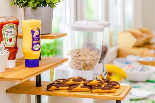 a couple of shelves with cookies on a table at Hotel Rio Beach & Breakfast in Cesenatico