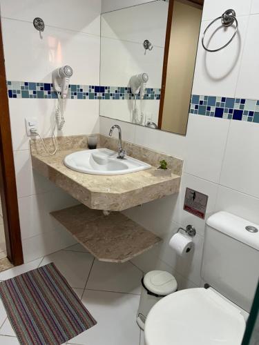 a bathroom with a sink and a toilet at Apartamento em João Fernandes - Búzios in Búzios