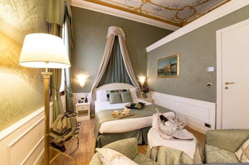 a hotel room with two beds and a lamp at Duodo Palace in Venice
