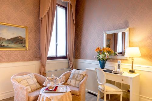 a room with two chairs and a desk and a window at Duodo Palace in Venice
