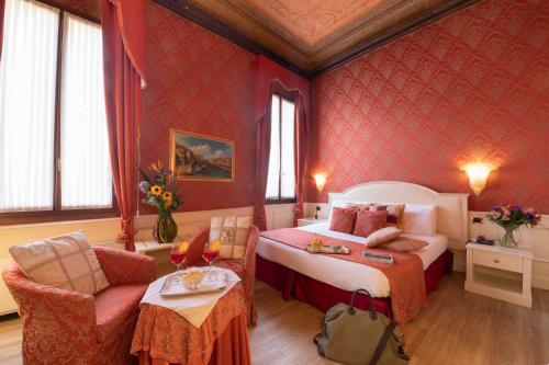 a hotel room with a bed and a chair at Duodo Palace in Venice