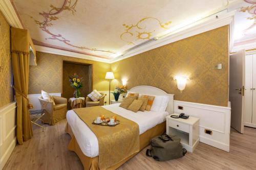 a hotel room with a king sized bed in a room at Duodo Palace in Venice