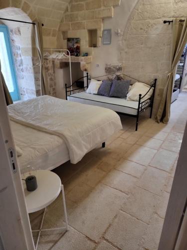 Postel nebo postele na pokoji v ubytování Trulli di Charme Eutuxia