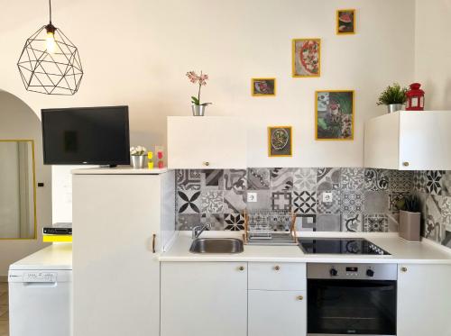 a kitchen with white cabinets and a sink at Vila Virago in Vir