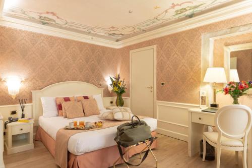a bedroom with a bed and a desk and a chair at Duodo Palace in Venice