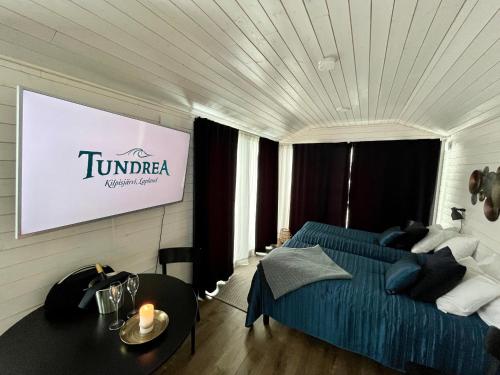 a hotel room with a bed and a sign on the wall at Tundrea Holiday Resort in Kilpisjärvi