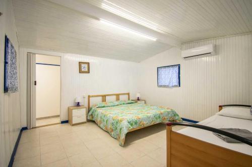 a bedroom with a bed in a room with a door at Camping Linus in Marina di Massa