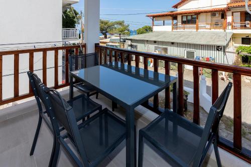a blue table and chairs on a balcony at Agapitos Apartments in Nikiti