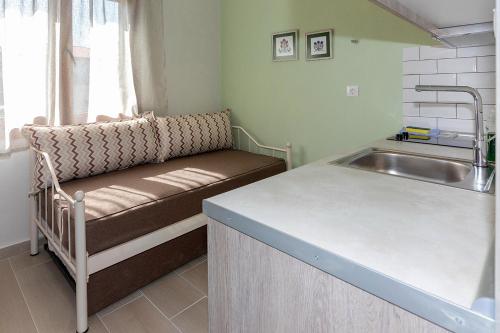 a kitchen with a bench next to a sink at Agapitos Apartments in Nikiti