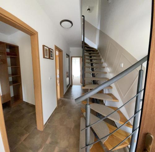 a winding staircase in a home with white walls at Resort-Restaurant Stilec in Kamenný Újezd
