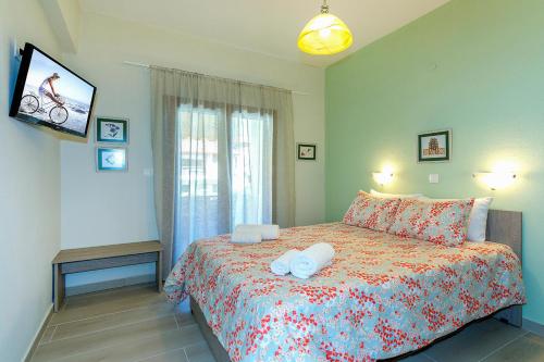 a bedroom with a bed with two towels on it at Agapitos Apartments in Nikiti