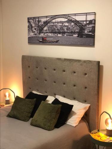 a black and white picture of a bridge above a bed at Angel by Prada City House in Vila Nova de Gaia