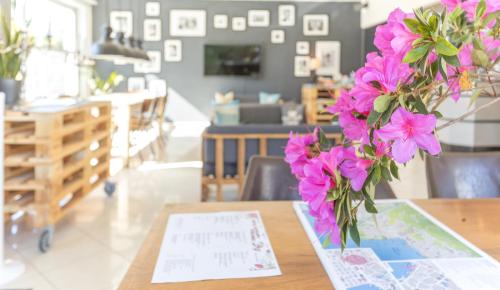 a vase filled with pink flowers sitting on a table at Albergo Mirador Ascona in Ascona