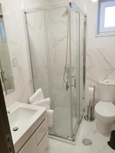 a bathroom with a shower and a toilet and a sink at Angel by Prada City House in Vila Nova de Gaia