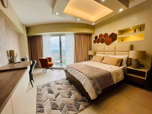 a bedroom with a large bed with a large window at AEON TOWERS STUDIO SUITE (by:skyspottravelcentra) in Davao City