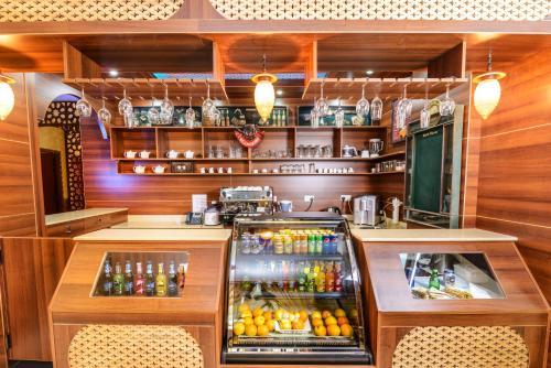 a bar with a display of drinks and bottles at Bravo Royal Hotel Suites in Kuwait