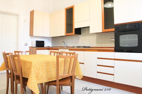 a kitchen with a table with a polka dot table cloth at Putignani 210 Apartment in Bari
