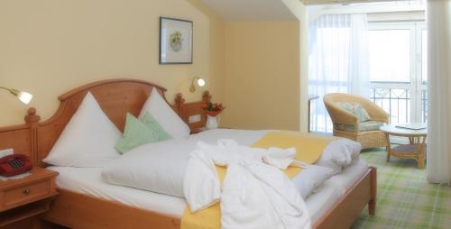 a bedroom with a bed with towels on it at Feriengut Waldblick in Sankt Oswald