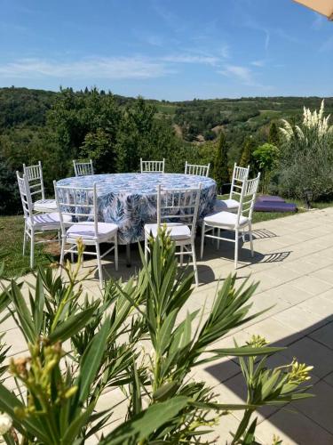 a table and chairs on a patio with a view at Zora’s Home in Irig