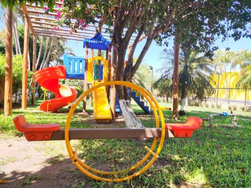 a playground in a park with a slide at Pousada Voo das Garças in Bonito
