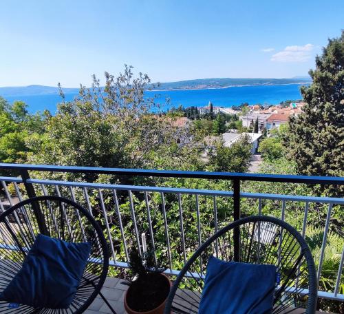 a bike sitting on a balcony with a view of the water at Apartmani Ankica in Crikvenica