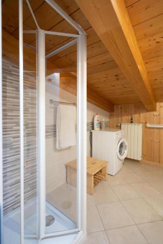 a bathroom with a glass shower in a house at Trabocco del Borgo in Treglio