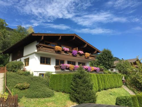 a house with flowers on top of it at Landhaus Bergner Alm in Bruck an der Großglocknerstraße