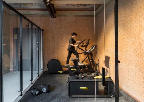 a man walking in a room with a gym at Antica Dimora Le Misure in Cervia