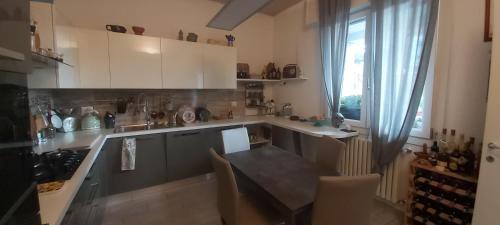 a kitchen with a table and a dining room at Casa Da Frida in San Giovanni in Persiceto