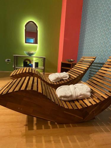 a large wooden bed sitting in a room at Hotel Riva Etrusca in Marina di Bibbona