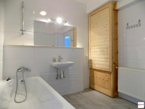 a bathroom with a tub and a sink and a bath tub at Romantic two bedroom apartment in the hills of Budapest with private parking in Budapest