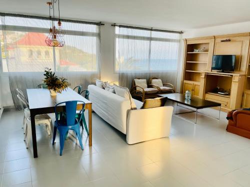 a living room with a couch and a table at La Marina SeaView Penthouse in Sitges