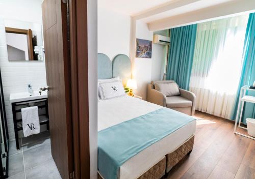 a hotel room with a bed and a chair at Cheers Vera Edition Hotel in Istanbul