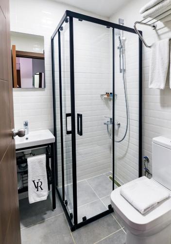 a bathroom with a shower and a toilet and a sink at Cheers Vera Edition Hotel in Istanbul