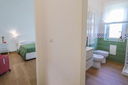 a bathroom with a bed and a toilet in a room at Acquasanta Relais in Laureana Cilento