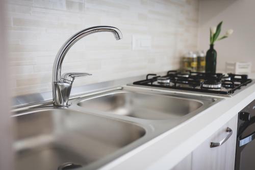 a stainless steel sink in a kitchen next to a stove at Acquasanta Relais in Laureana Cilento