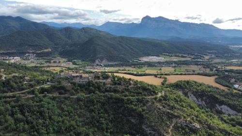 an aerial view of a valley with a river and mountains at Hotel Rural LAbadia de Sieste in Sieste
