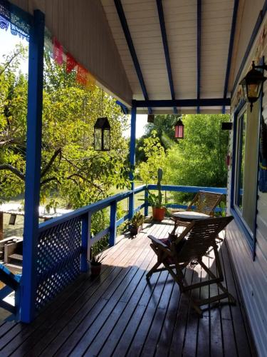 a wooden deck with a table and chairs on it at Itaca delta cabañas in Tigre