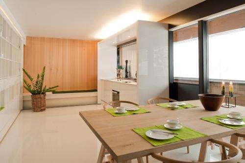 a dining room with a wooden table and chairs at Kar Design Appartements in Lech am Arlberg