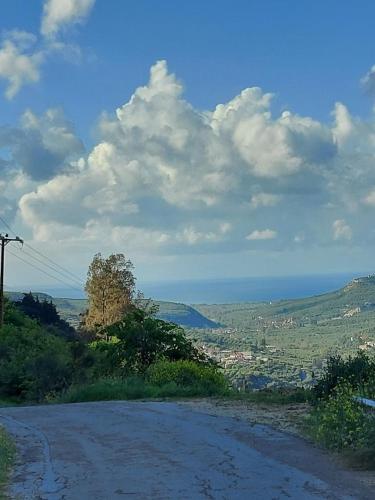 a dirt road with a view of a city at Mouri Village in Aïkiryiánnis