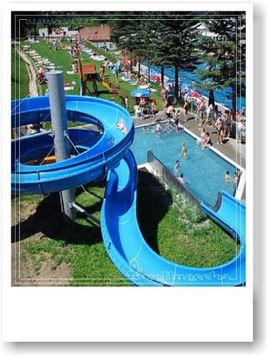 a blue water slide at a park with people in it at Wellnesska Vyhne in Vyhne
