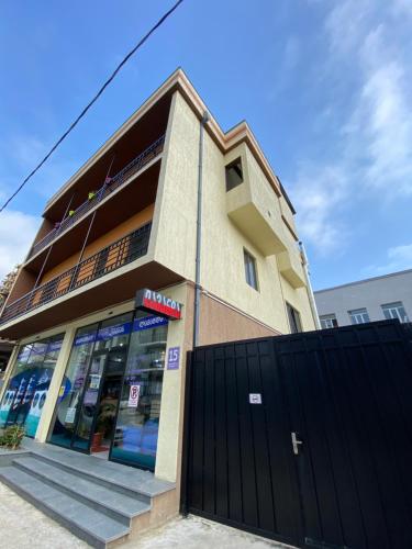 a store front of a building with a black gate at Lovely and cozy apartment! in Kutaisi