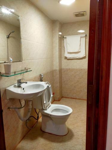 a bathroom with a toilet and a sink at Rose in Hue