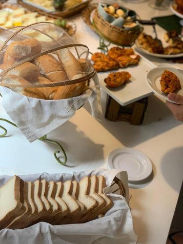 a table with a bunch of different types of food at Pousada Cheiro Verde in Arraial d'Ajuda