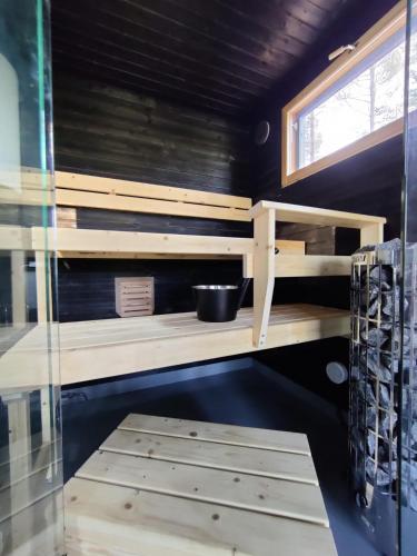 a sauna with wooden shelves and a window at Golf Villa B Siikajoki in Siikajoki