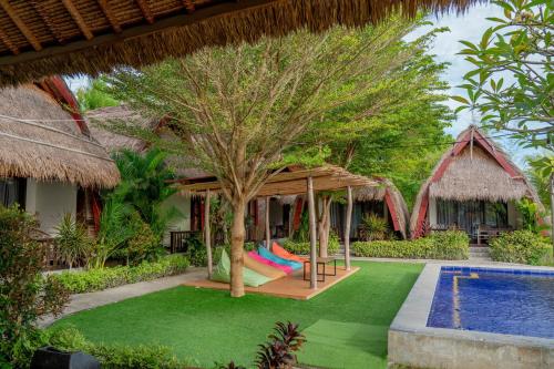 a resort with a hammock and a swimming pool at Krisna Bungalows and Restaurant in Sekotong