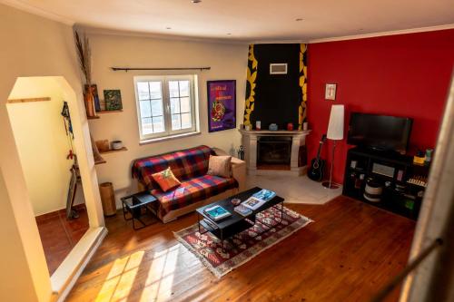 a living room with a couch and a tv at Ahoy Surf House in Ferrel