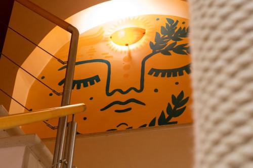 a lamp with a lion painted on the wall at Ahoy Surf House in Ferrel